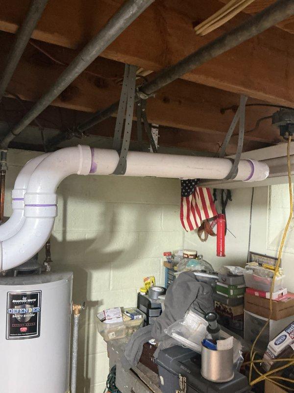 Completed full HVAC system installation including a 70,000 BTU furnace and 2-ton air conditioning unit with rear placement configuration. Obtained mechanical and electrical permits prior to installation, installed all necessary ductwork, condensate drainage lines, and electrical connections, then performed system reconnection and startup. All equipment tested and operational upon completion, with job site photos documenting the outdoor condenser unit placement and basement furnace installation with associated PVC venting and drainage systems.