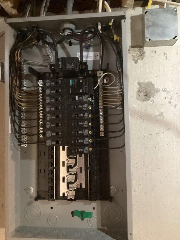 Successfully completed installation of 100-amp electrical service panel upgrade. Removed existing panel and installed new load center with dual-row circuit breaker configuration, copper bus bars, and proper grounding connections. All branch circuit wiring was terminated to appropriate breakers, with connections made to brass terminal strips and copper lugs at the main service entrance. Panel was mounted securely to interior wall in utility space with proper clearances maintained. All work performed in coordination with HVAC installation occurring same day, and permits were obtained prior to commencement of work.