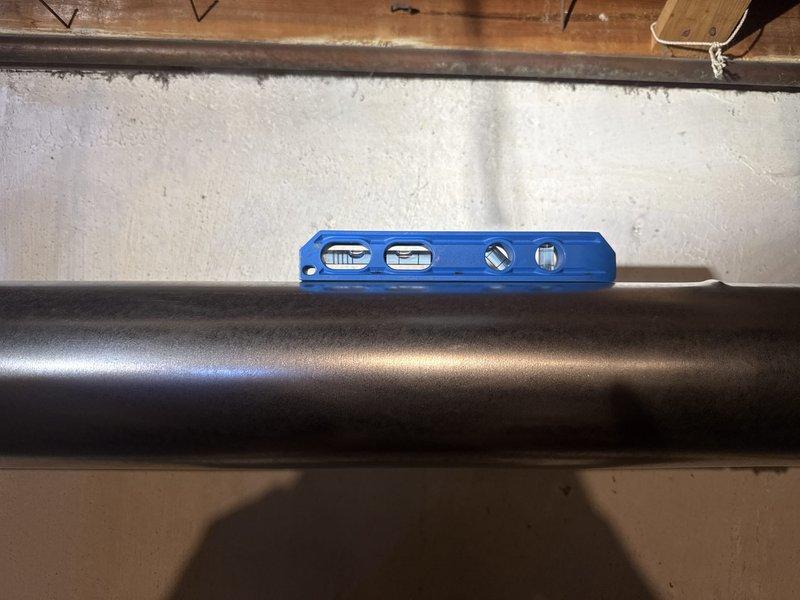 Completed full HVAC system installation including a 70,000 BTU furnace and 2.5 ton air conditioning unit with rear discharge configuration. Coordinated with electrical panel upgrade to 100 amp service performed same day to support new equipment load requirements. Installed all necessary ductwork connections, leveled equipment on proper mounting platform, and completed system reconnection. Obtained required mechanical and electrical permits prior to installation. Verified proper equipment alignment and secure mounting of both furnace and AC condenser units in basement mechanical room with all black ductwork properly connected and sealed.