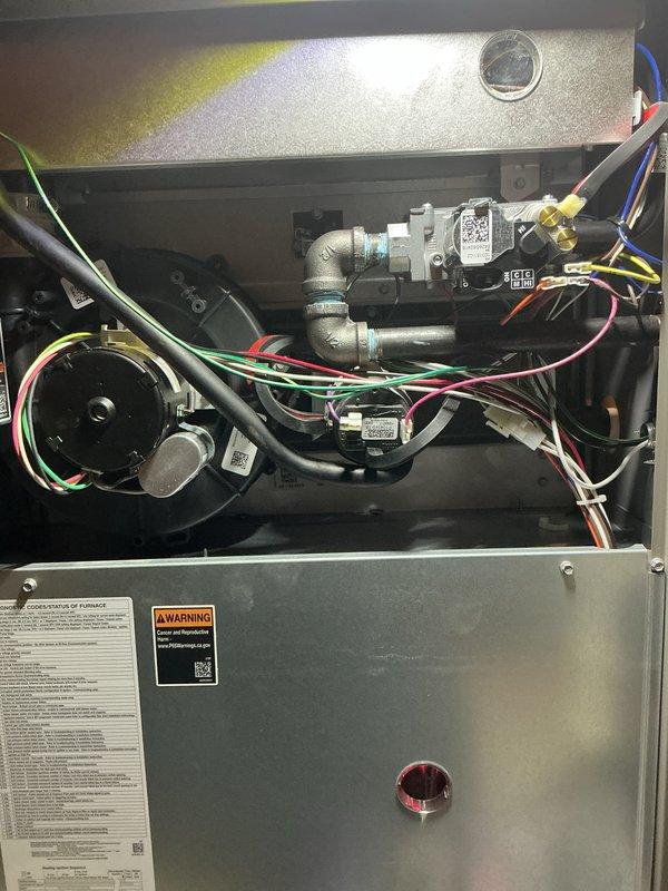 Completed annual heating maintenance tune-up on furnace as part of Air Care Membership. Performed comprehensive inspection of all system components including blower motor assembly, heat exchanger, gas valve assembly, electrical connections, and ductwork. Verified proper operation of all safety controls, checked wiring connections throughout the unit, and confirmed furnace is functioning correctly with no issues identified. Unit photographed for service records showing interior components and overall system condition.