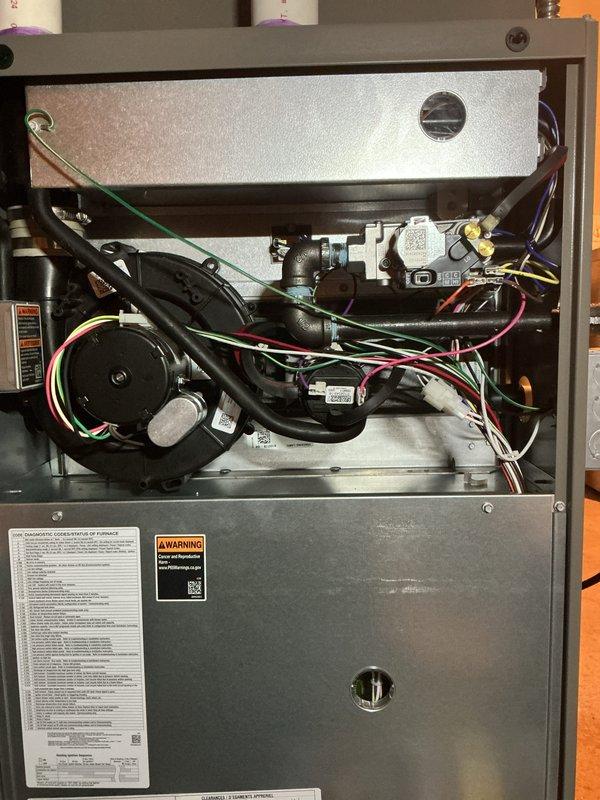 Completed annual heating maintenance tune-up on furnace as part of Air Care Membership. Performed comprehensive inspection of all system components including blower motor assembly, heat exchanger, gas valve assembly, electrical connections, and ductwork. Verified proper operation of all safety controls, checked wiring connections throughout the unit, and confirmed furnace is functioning correctly with no issues identified. Unit photographed for service records showing interior components and overall system condition.