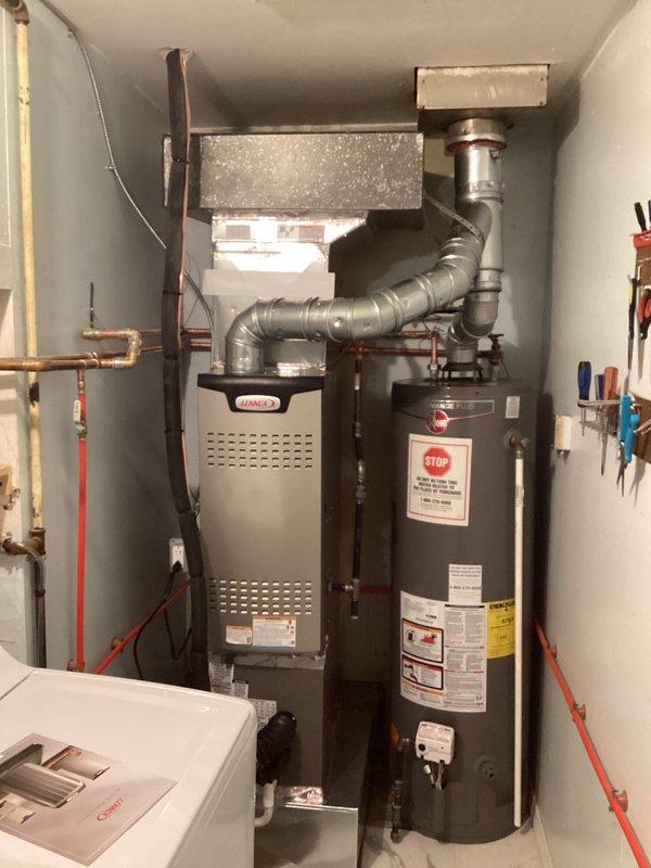 Completed full HVAC system installation including Lennox SL280DF070V36AK-01 furnace with 70,000 BTU input capacity and 2-ton air conditioning unit with rear discharge configuration. Installed new flue liner, set manifold pressure for natural gas operation, verified proper temperature rise parameters, and reconnected all existing ductwork and electrical connections. System tested and operational within manufacturer specifications.