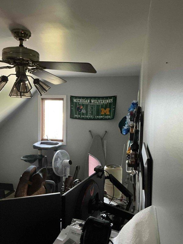 Conducted site assessment for new Mitsubishi ductless mini split installation to provide heating and cooling for one or two second-floor home office rooms currently used as workout space. Evaluated interior mounting locations in attic-level room with sloped ceiling and existing ceiling fan, and inspected exterior electrical service panel and available wall space for outdoor condenser placement. Documented existing electrical infrastructure including meter location, conduit routing, and foundation access points to provide comprehensive quote for first-time ductless system installation with no existing ductwork.