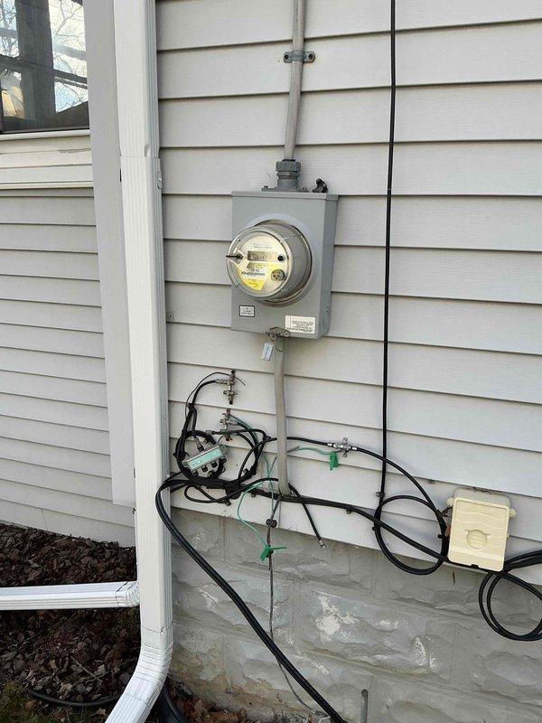 Conducted site assessment for new Mitsubishi ductless mini split installation to provide heating and cooling for one or two second-floor home office rooms currently used as workout space. Evaluated interior mounting locations in attic-level room with sloped ceiling and existing ceiling fan, and inspected exterior electrical service panel and available wall space for outdoor condenser placement. Documented existing electrical infrastructure including meter location, conduit routing, and foundation access points to provide comprehensive quote for first-time ductless system installation with no existing ductwork.