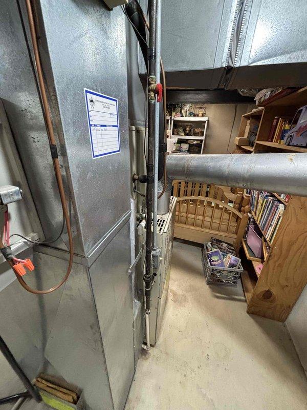 Provided comprehensive estimate for replacement of 30-year-old furnace and air conditioning system located in basement utility area. Existing equipment remains operational but has reached end of expected service life, requiring full system replacement recommendation with updated HVAC units and necessary ductwork modifications.