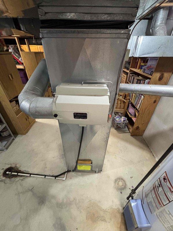 Provided comprehensive estimate for replacement of 30-year-old furnace and air conditioning system located in basement utility area. Existing equipment remains operational but has reached end of expected service life, requiring full system replacement recommendation with updated HVAC units and necessary ductwork modifications.