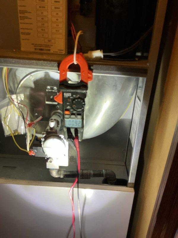 Completed annual furnace maintenance and tune-up on brand new furnace system. Inspected air handler interior components, verified proper filter installation and condition of green filter media within white metal casing. Performed electrical diagnostics using clamp meter to measure current draw and verify proper system operation, tested all electrical connections and wiring throughout the cabinet. Checked condensate pump assembly and associated tubing for proper function. All components operating within manufacturer specifications, system ready for continued service.