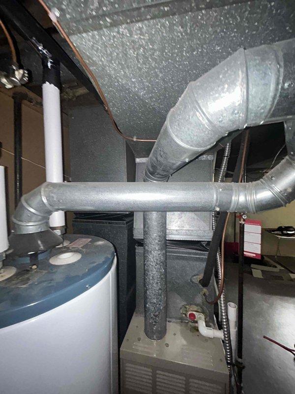 Provided estimate for replacement of non-operational 1998 natural gas furnace located in basement. Unit had been shut off due to failure and required full system replacement. Assessed existing ductwork configuration, water heater proximity, and mechanical room layout to determine proper equipment sizing and installation requirements for new furnace system.