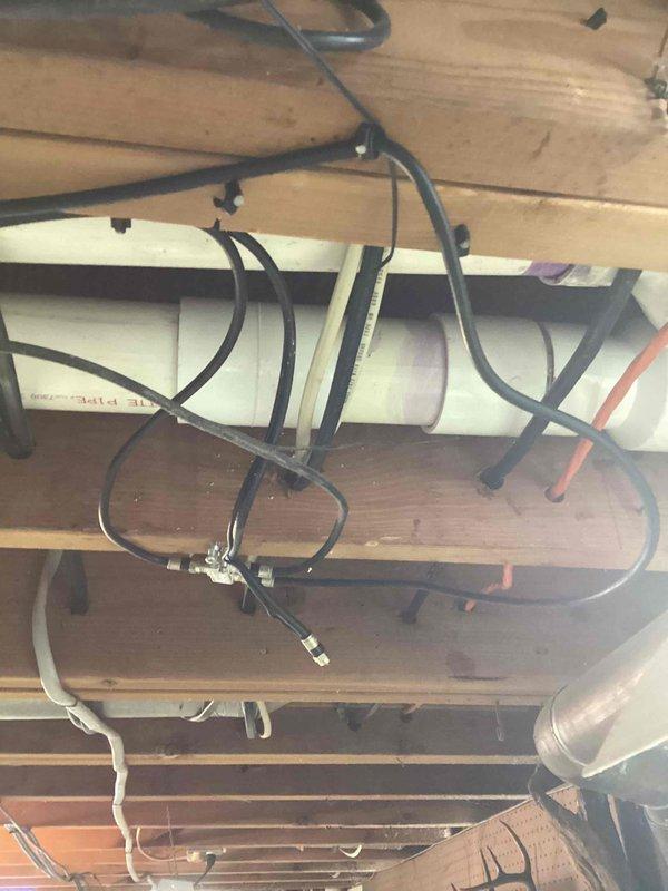 Responded to callback for water leakage at furnace exhaust penetration point. Inspected 90,000 BTU furnace and 3-ton air conditioning system installation in basement, focusing on PVC exhaust venting where it exits through exterior wall. Examined condensate drainage routing, PVC pipe joints, and penetration sealing to identify source of interior water intrusion and made necessary corrections to prevent further leakage.