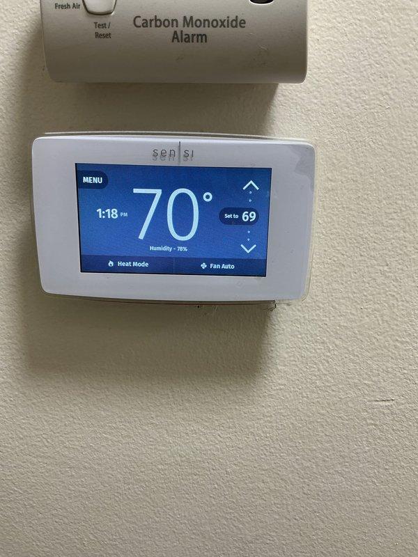 Completed routine Air Care Heating and Cooling maintenance inspection on HVAC system. Verified proper operation of Sensi digital thermostat in both heating and cooling modes, confirmed accurate temperature readings and humidity monitoring functionality at 70°F with system cycling appropriately. Documented carbon monoxide alarm and thermostat in good working condition with no service issues identified.