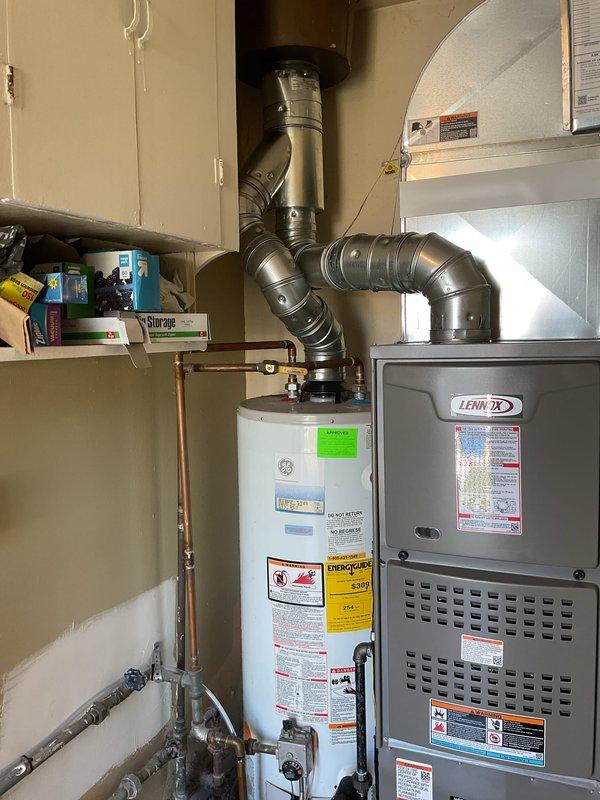Completed full HVAC system installation including a Lennox 70,000 BTU furnace and 1.5 ton air conditioning unit with rear discharge configuration. Installed new dedicated electrical circuit to support the system, positioned furnace in utility closet with proper venting and ductwork connections, and integrated condensate pump with drainage tubing for moisture management. All mechanical and electrical permits were obtained prior to installation, and system was installed alongside existing water heater in residential mechanical room with all required safety labels, specifications, and manufacturer documentation properly affixed to equipment.