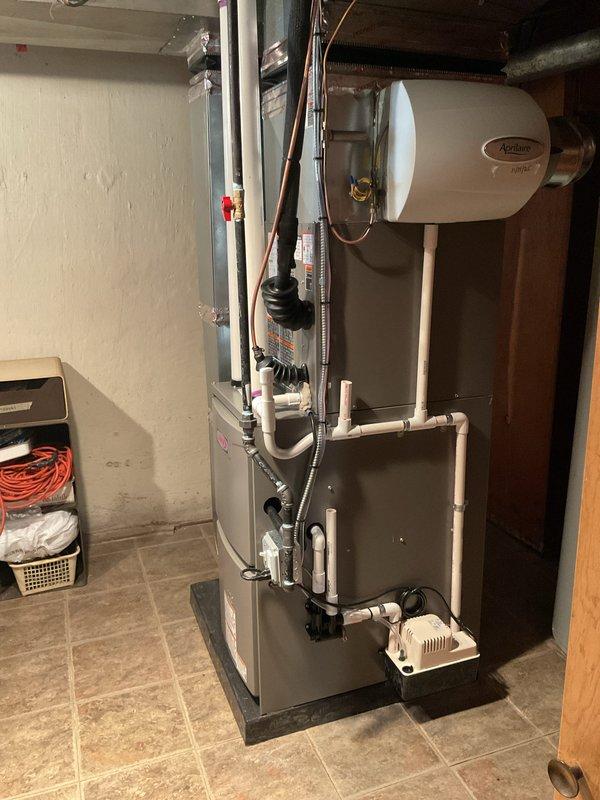 Completed full HVAC system installation including a 70,000 BTU furnace (model ML196UHD70TXS5A) and 2-ton air conditioning unit with rear discharge configuration. Installed all necessary refrigerant lines, electrical connections, condensate drainage piping, and ductwork connections in basement mechanical room. System tested, reconnected to existing infrastructure, and verified operational per manufacturer specifications with all required mechanical and electrical permits obtained.