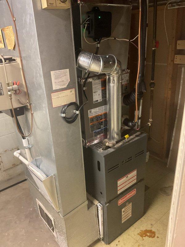 Completed installation of 2-ton air conditioning system with matching evaporator coil at rear location. Installed new outdoor condensing unit on existing concrete pad with proper refrigerant line connections and electrical service reconnection. Mounted new evaporator coil above existing furnace in basement utility area with copper refrigerant piping, condensate drainage, and integrated electrical controls. All mechanical and electrical permits obtained prior to installation, system tested and operational upon completion.
