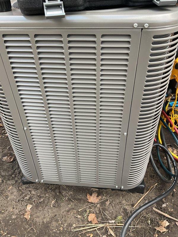 Completed installation of 2-ton air conditioning system with matching evaporator coil at rear location. Installed new outdoor condensing unit on existing concrete pad with proper refrigerant line connections and electrical service reconnection. Mounted new evaporator coil above existing furnace in basement utility area with copper refrigerant piping, condensate drainage, and integrated electrical controls. All mechanical and electrical permits obtained prior to installation, system tested and operational upon completion.
