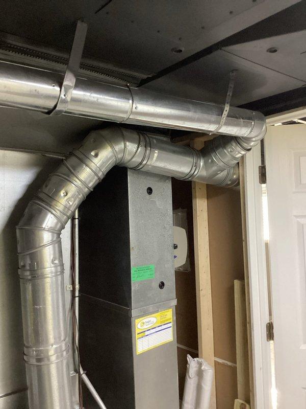 Responded to service call for leaking tanked water heater discovered during home inspection by new homeowners. Inspected water heater and confirmed minor leak with containment in place. Additionally evaluated furnace flue pipe as requested, identifying improper pitch with visible dip in horizontal run that requires correction to ensure proper draft and code compliance. Documented existing conditions of both water heater leak and furnace flue configuration with photographs. Provided recommendations for water heater repair or replacement based on unit age and extent of leak, and advised on furnace flue pipe resloping or replacement to achieve proper upward angle for safe exhaust ventilation.