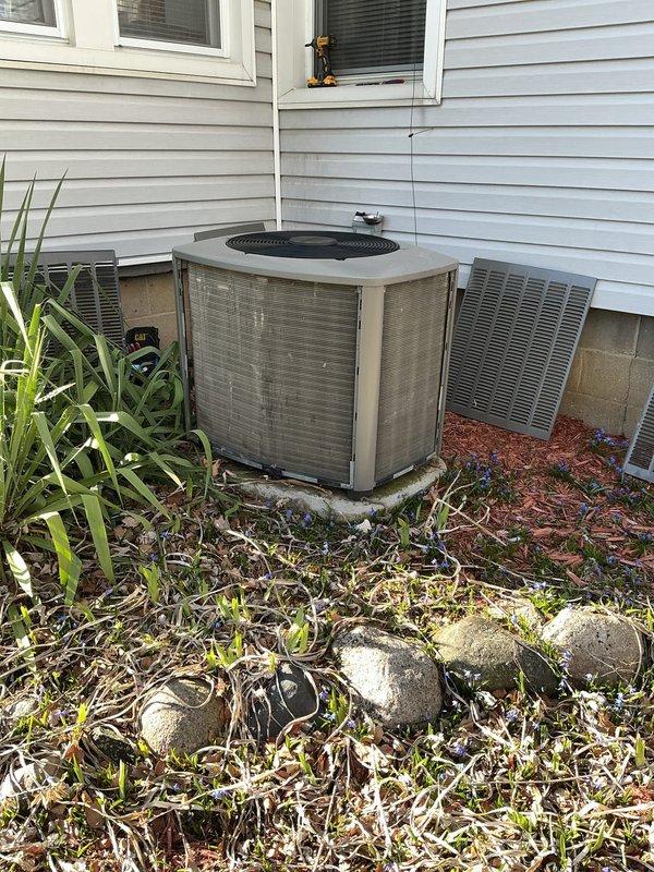 Completed scheduled ACM maintenance on residential outdoor condensing unit. Performed visual inspection of equipment exterior, noting normal weathering and dirt accumulation on cabinet panels consistent with outdoor exposure. Unit positioned on stable concrete pad with adequate clearance; observed detached access panel requiring reinstallation. Documented equipment condition through photographic records showing unit accessible for routine maintenance with surrounding landscaping requiring minor debris clearance for optimal airflow.