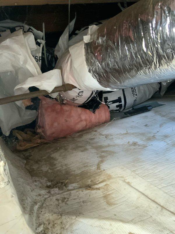 Conducted indoor air quality assessment and estimate for 100-year-old home with exterior package unit and crawlspace ductwork. Inspected existing electrical panel for capacity to support potential IAQ equipment additions, documented attic space conditions including current insulation state with pink fiberglass and reflective barrier materials, and evaluated infrastructure compatibility for proposed air quality system integration.