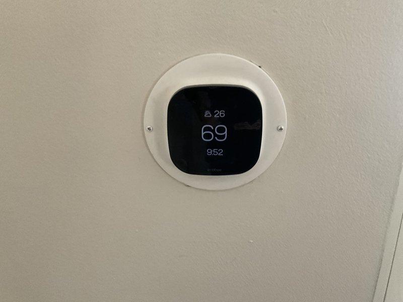 Completed HVAC system evaluation for replacement estimate on non-operational 35+ year old Lennox air conditioning condenser unit located on exterior concrete pad and basement furnace equipment. Assessed existing outdoor condenser showing significant weathering and age-related deterioration, documented electrical disconnect and refrigerant line routing through foundation, and evaluated natural gas furnace compatibility for complete system replacement recommendation.