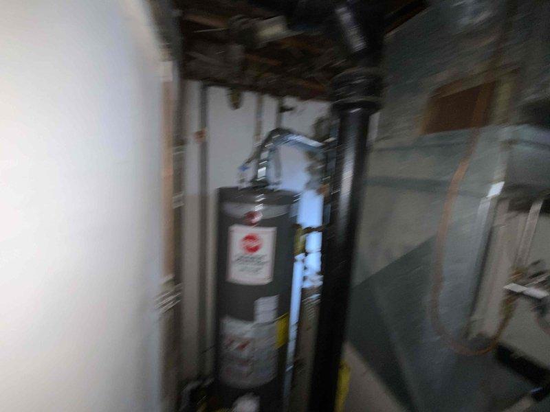 Conducted comprehensive assessment of existing 30-35 year old natural gas furnace and air conditioning system located in basement for equipment replacement estimate. Current HVAC system operational but nearing end of service life. Evaluated existing ductwork, ventilation components, and mechanical connections including gas lines, electrical supply, and condensate drainage systems. Documented equipment specifications, clearance requirements, and installation considerations for replacement units. Reviewed galvanized ductwork condition showing moisture accumulation and surface corrosion requiring attention during installation. Assessed utility connections and determined compatibility requirements for new high-efficiency equipment installation.