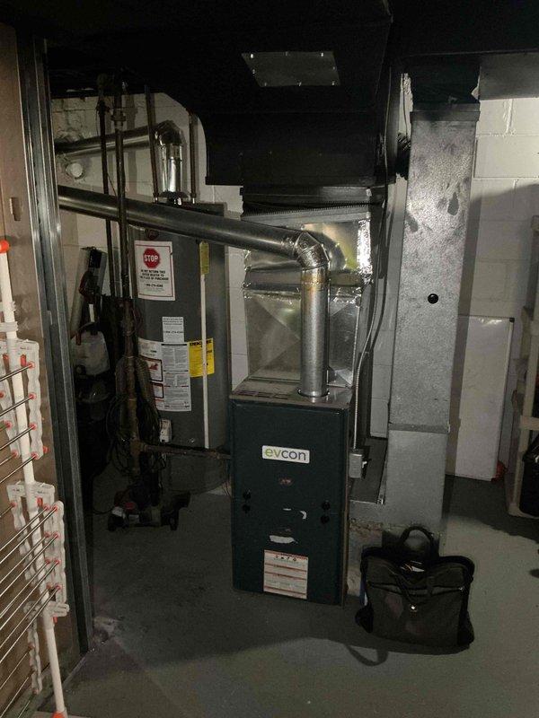 Provided comprehensive estimate for replacement of aging Evcon furnace and air conditioning system located in basement mechanical room. Current equipment is operational but has reached end of useful service life. Evaluated existing ductwork configuration, electrical connections, and installation space requirements for new HVAC system replacement.