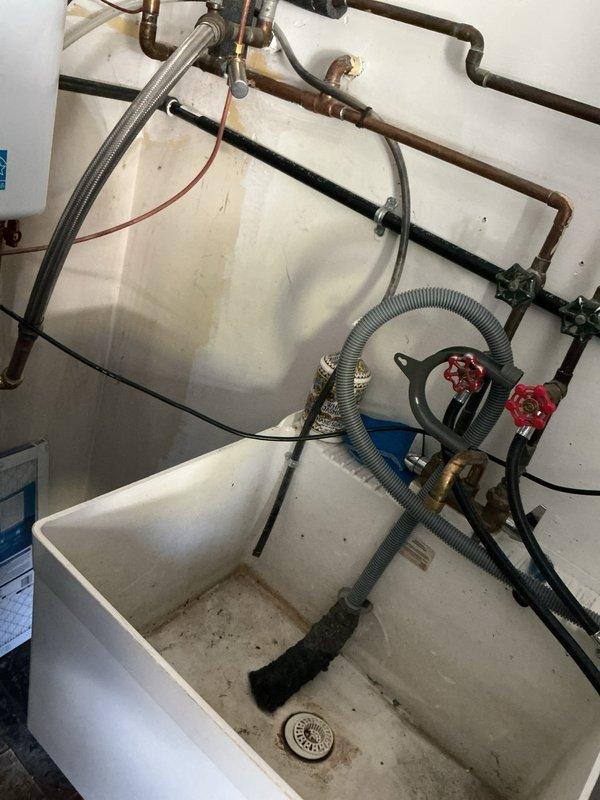 Serviced humidifier system and discovered extensive black mold growth throughout the water supply tubing and basin. Due to the severity of contamination and age of the unit (manufactured 11/2025), recommended replacement of affected components to ensure proper indoor air quality and prevent health hazards from mold spore circulation through the HVAC system.
