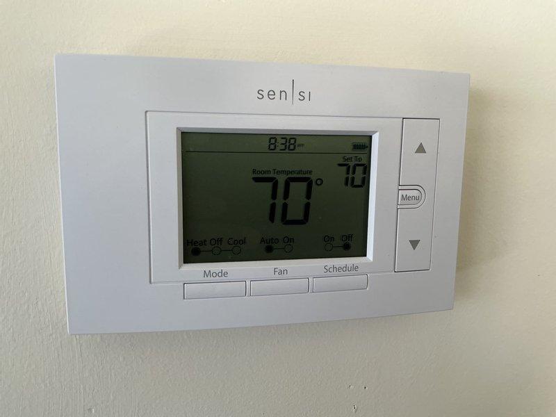 Completed comprehensive annual HVAC maintenance inspection covering both heating and cooling systems. Verified thermostat operation and calibration at 70°F, confirmed proper system response and scheduling functions on Sensi digital unit. Performed electrical diagnostics using multimeter to measure voltage and amperage readings on system components, ensuring all values within manufacturer specifications at 045 reading. Inspected refrigerant lines, mounting brackets, and overall system integrity with all components functioning properly and no issues identified during routine preventive maintenance service.