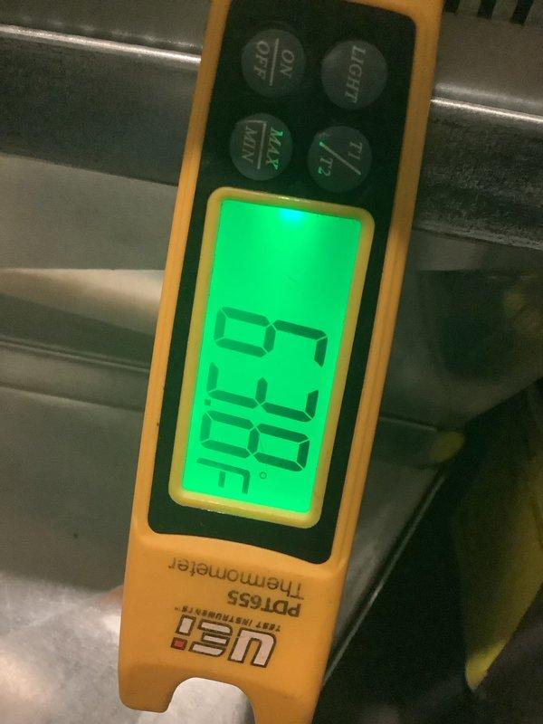 Completed annual cooling maintenance on air conditioning system. Performed comprehensive inspection of all major components including capacitor evaluation and temperature diagnostics. Measured supply air temperature at 62.0°F using calibrated digital thermometer to verify proper system operation. Inspected run capacitor rated at 370V for physical condition, noting surface wear and discoloration patterns consistent with normal operation. Examined evaporator coil showing oxidation on copper fins, typical of system age and environmental exposure. All components found functioning within acceptable parameters for continued operation through cooling season.