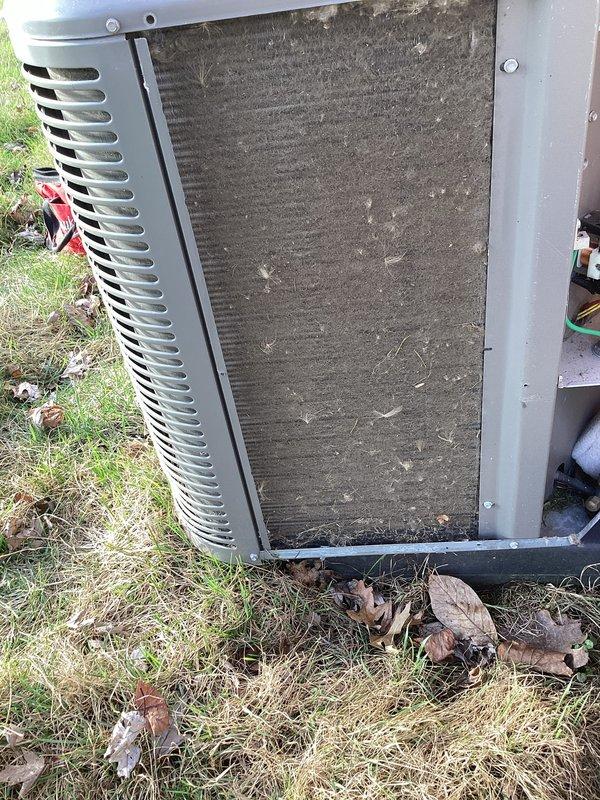 Completed annual cooling maintenance on outdoor condensing unit. Upon arrival, found condenser coil heavily clogged with dirt, dust, and organic debris, significantly restricting airflow. Removed accumulated leaves, twigs, and vegetation from base and surrounding area of unit. Thoroughly cleaned condenser coil to restore proper heat transfer efficiency. Inspected all accessible components, verified proper operation of condenser fan, and confirmed unit returned to normal operating condition.