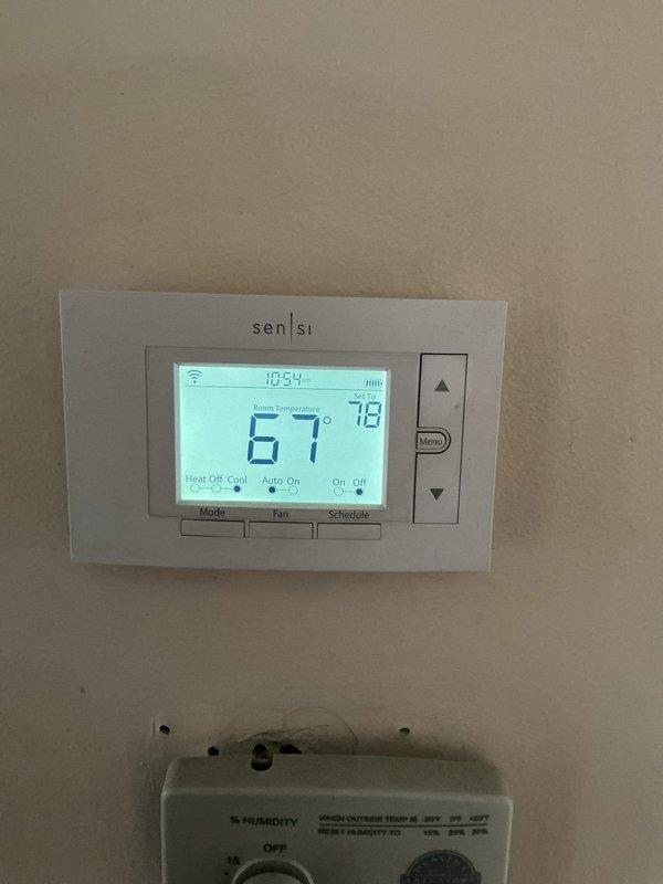 Completed scheduled ComfortGuard Maintenance visit including filter replacement and system inspection. Verified proper operation of Sensi digital thermostat displaying 67°F current temperature with 79°F setpoint, confirmed WiFi connectivity and programming functions, and checked humidifier control settings for optimal indoor air quality management.