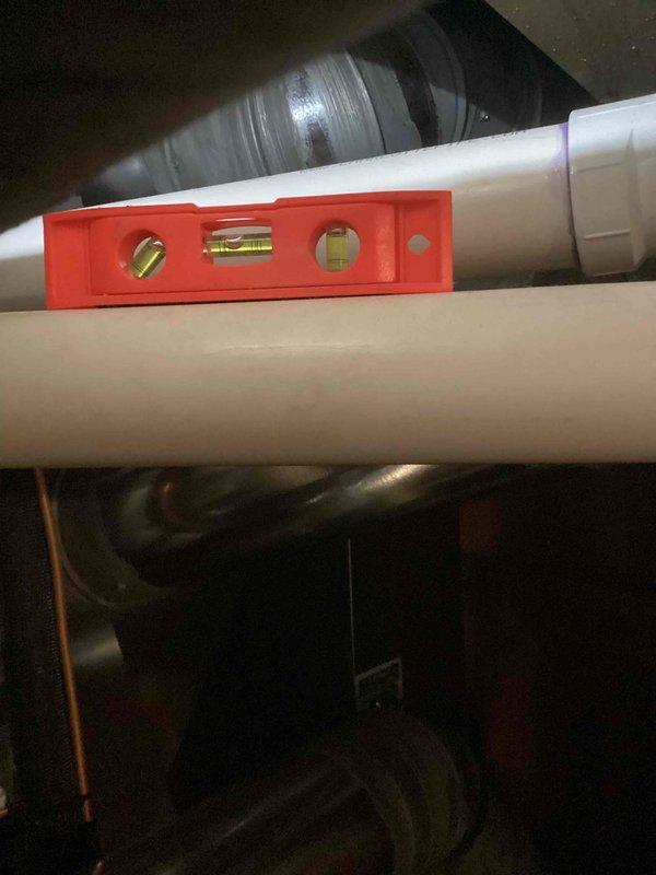Responded to service call for furnace not heating due to GFI circuit repeatedly tripping on unit less than one year old. Performed diagnostic inspection and identified improper condensate drain line installation causing electrical safety issues. Corrected PVC condensate drain pipe alignment and pitch using level to ensure proper gravity drainage, preventing water backup that was triggering ground fault protection. Verified all connections secure, tested system operation, and confirmed furnace heating properly with GFI remaining stable under full load conditions.