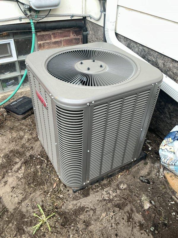 Completed annual HVAC maintenance on residential air conditioning condenser unit. Performed system diagnostics including electrical testing with multimeter, which indicated normal operating voltage at 27.0 volts on control circuit. Inspected outdoor unit for proper operation, verified condensate drainage system functionality, and documented equipment condition with photos for service records.