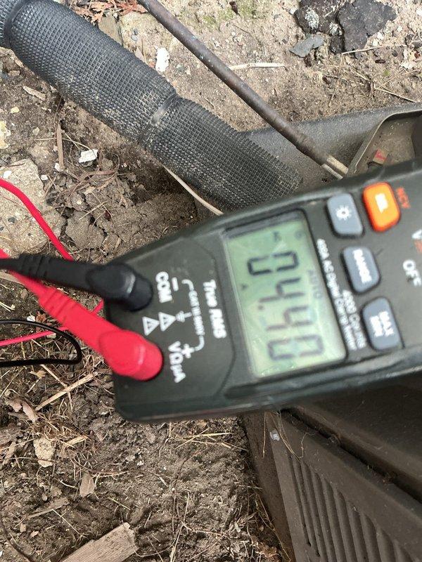 Completed annual HVAC maintenance on residential air conditioning condenser unit. Performed system diagnostics including electrical testing with multimeter, which indicated normal operating voltage at 27.0 volts on control circuit. Inspected outdoor unit for proper operation, verified condensate drainage system functionality, and documented equipment condition with photos for service records.