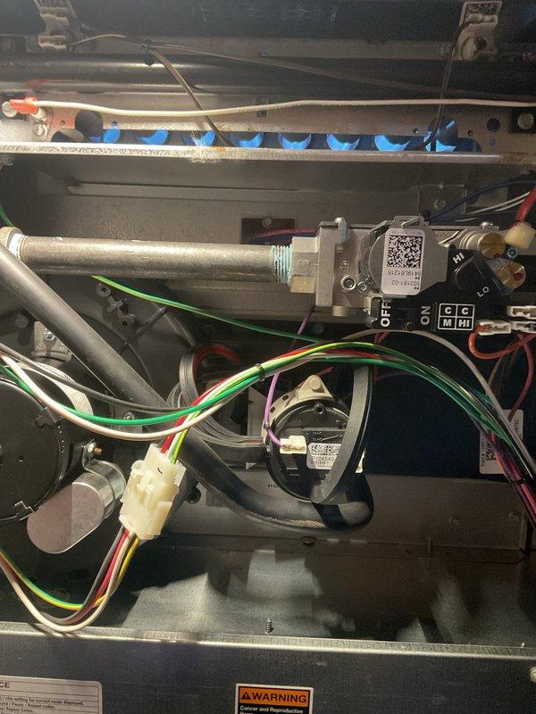 Completed comprehensive ComfortGuard preventive maintenance inspection on residential gas furnace system. Performed thorough examination of all internal components including burner assembly with ignition ports, gas valve and piping connections, blower motor assembly, electrical wiring harnesses, control board functionality, and UV air purification system. All system components found operating within normal parameters with no deficiencies noted at time of service.