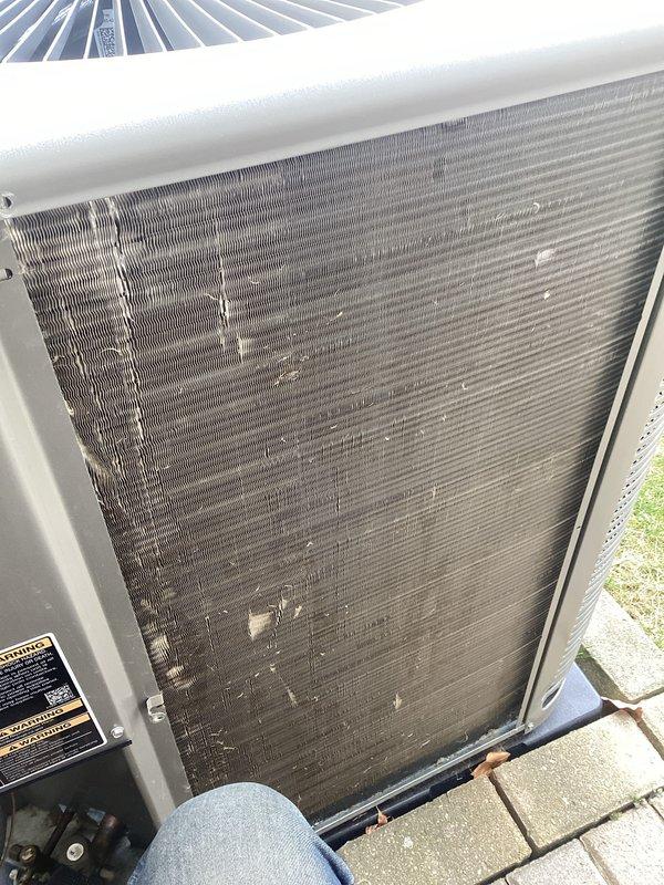 Completed annual maintenance on outdoor air conditioning unit. Upon inspection, discovered severe condenser coil deterioration with extensive fin corrosion affecting more than half of the coil surface, significantly compromising system efficiency and heat transfer capability. Documented coil condition with photos showing advanced degradation patterns and material loss throughout the fins. Cleaned accessible coil sections and removed accumulated dirt, dust, and debris buildup from condenser coil surfaces. Verified condensate drainage system operation and inspected all accessible components. Recommend immediate condenser coil replacement due to extensive deterioration that will impact cooling capacity and system performance.