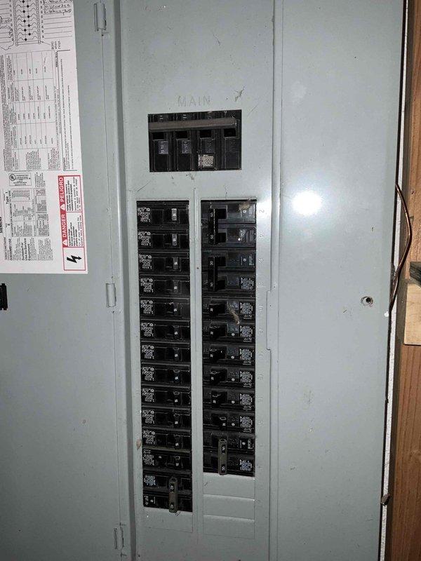Conducted on-site evaluation for replacement of failed condenser unit on a 10-year-old air conditioning system. Upon inspection of the existing HVAC equipment in the basement mechanical room, assessed the current furnace, air handler, and associated ductwork configuration. Documented the electrical service panel to verify adequate capacity for new equipment installation. Evaluated the existing system layout including flexible ductwork connections, filter cabinet positioning, and available clearances for replacement condenser unit. Photographed current equipment specifications and configuration to prepare accurate replacement estimate for complete condenser unit replacement.