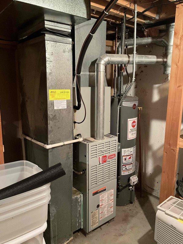 Conducted on-site evaluation for replacement of failed condenser unit on a 10-year-old air conditioning system. Upon inspection of the existing HVAC equipment in the basement mechanical room, assessed the current furnace, air handler, and associated ductwork configuration. Documented the electrical service panel to verify adequate capacity for new equipment installation. Evaluated the existing system layout including flexible ductwork connections, filter cabinet positioning, and available clearances for replacement condenser unit. Photographed current equipment specifications and configuration to prepare accurate replacement estimate for complete condenser unit replacement.