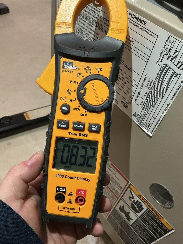 Responded to no heat call on 10+ year old furnace with intermittent cycling issues. Upon arrival, performed diagnostic testing using clamp meter to measure electrical current draw and system performance. Measured amp draw readings of 2.32A and 2.1A during operation cycles, indicating potential issues with blower motor or ignition system components. Documented furnace nameplate specifications and electrical readings with photos for service records. System requires further evaluation to determine root cause of intermittent cycling and heating failures, likely related to age-related component degradation in ignition control, flame sensor, or limit switch assembly.