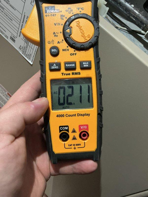 Responded to no heat call on 10+ year old furnace with intermittent cycling issues. Upon arrival, performed diagnostic testing using clamp meter to measure electrical current draw and system performance. Measured amp draw readings of 2.32A and 2.1A during operation cycles, indicating potential issues with blower motor or ignition system components. Documented furnace nameplate specifications and electrical readings with photos for service records. System requires further evaluation to determine root cause of intermittent cycling and heating failures, likely related to age-related component degradation in ignition control, flame sensor, or limit switch assembly.