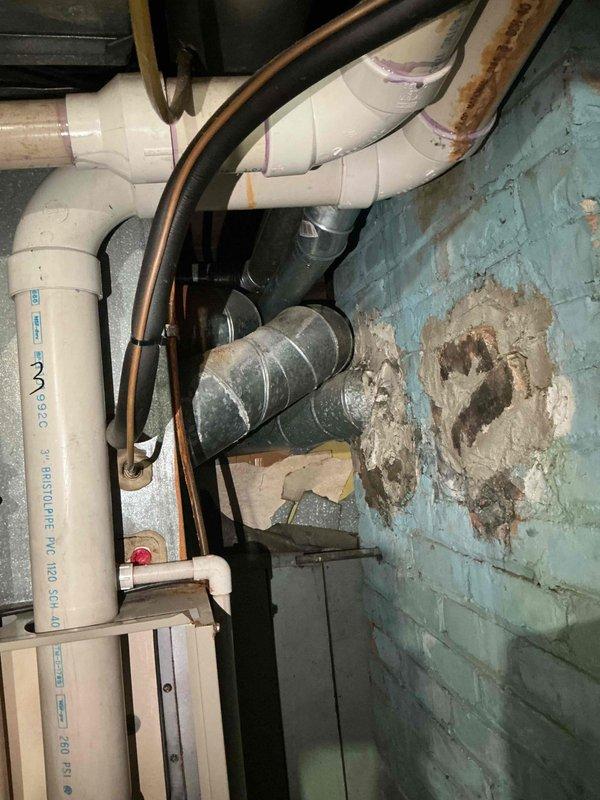 Conducted estimate for complete HVAC system replacement in basement location. Existing furnace and air conditioning unit are non-operational and have reached end of service life at 25-30 years old. Evaluated current installation including utility area with existing ductwork, plumbing infrastructure, and electrical connections. Assessed basement mechanical room conditions including painted cinder block walls showing moisture deterioration, existing PVC drain and vent lines, copper refrigerant piping, and metal supply ductwork. Documented installation space constraints and utility routing for proper equipment sizing and placement recommendations. Provided comprehensive replacement options for new high-efficiency heating and cooling system appropriate for residential application.