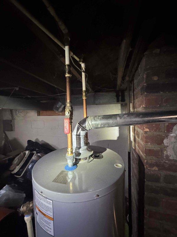 Conducted site assessment for new air conditioning system installation at residence with no existing AC unit. Evaluated basement utility area and mechanical room infrastructure, documenting existing HVAC infrastructure, electrical service access points, and available space for equipment placement. Photographed current conditions including water heater location, exposed brick and concrete block walls, ceiling clearances, and existing ductwork to determine optimal routing for new refrigerant lines and condensate drainage. Prepared comprehensive quote for complete air conditioning system installation including indoor air handler, outdoor condensing unit, refrigerant piping, electrical connections, and thermostat controls.