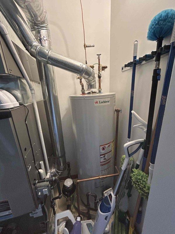 Provided comprehensive estimate for water heater replacement options in ranch-style home, including both standard and tankless configurations. Assessed existing Lochinvar natural draft water heater in utility room alongside HVAC system, noting current unit operational status and existing copper piping infrastructure. Documented mechanical room layout and plumbing connections to determine installation requirements for new tankless water heater system as requested alternative to standard replacement.