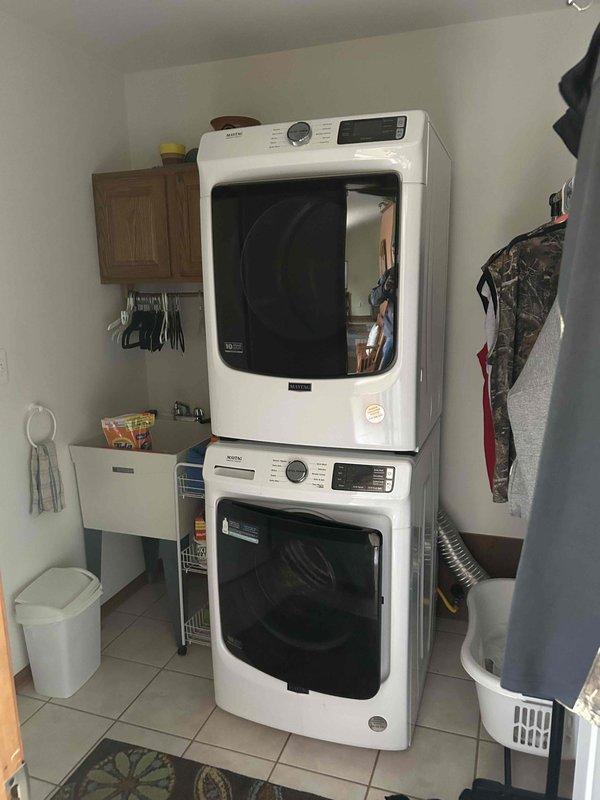 Provided comprehensive estimate for water heater replacement options in ranch-style home, including both standard and tankless configurations. Assessed existing Lochinvar natural draft water heater in utility room alongside HVAC system, noting current unit operational status and existing copper piping infrastructure. Documented mechanical room layout and plumbing connections to determine installation requirements for new tankless water heater system as requested alternative to standard replacement.