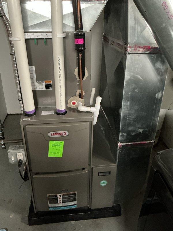 Completed annual maintenance on Lennox furnace system. Performed comprehensive tune-up including inspection of all major components, heat exchanger, burner assembly, and ignition system. Verified proper operation of blower motor, checked and cleaned flame sensor, and tested safety controls. Inspected PVC venting system and condensate drain lines for proper drainage and secure connections. Examined ductwork and plenum connections for air leaks. Confirmed gas pressure and combustion efficiency within manufacturer specifications. Tested thermostat operation and system cycling. All components functioning properly with no deficiencies noted. System operating safely and efficiently. Documented service with photos for maintenance records.
