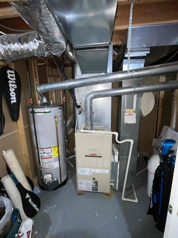Provided comprehensive estimate for replacement of 25-year-old furnace and air conditioning system currently located in basement mechanical room. Existing equipment remains operational but has reached end of expected service life. Assessment included evaluation of current beige furnace unit, associated ductwork system, clearances, and utility connections to determine proper specifications for replacement HVAC system.