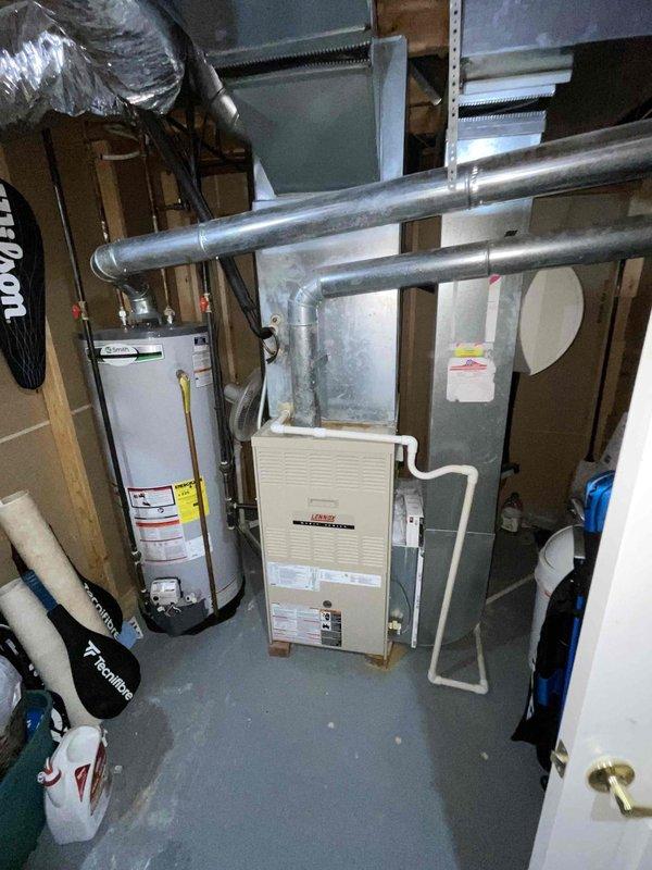 Provided comprehensive estimate for replacement of 25-year-old furnace and air conditioning system currently located in basement mechanical room. Existing equipment remains operational but has reached end of expected service life. Assessment included evaluation of current beige furnace unit, associated ductwork system, clearances, and utility connections to determine proper specifications for replacement HVAC system.