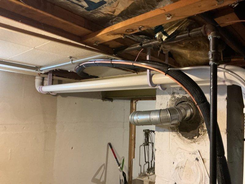 Completed full HVAC system installation including a 70,000 BTU furnace and 2-ton air conditioning unit with rear discharge configuration. Obtained mechanical and electrical permits prior to installation, installed Lennox air handler with proper PVC condensate drainage and venting, connected all ductwork with appropriate metal strapping and hangers, and reconnected existing electrical service. All equipment properly mounted, secured, and tested for operation in basement mechanical room.