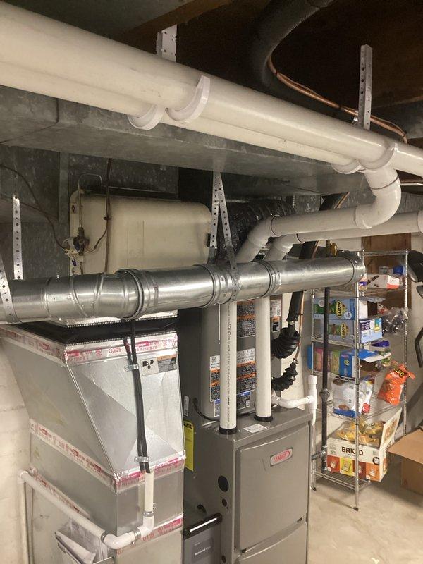 Completed full HVAC system installation including a Lennox 70,000 BTU furnace and 2-ton air conditioning unit positioned on the right side of the property. Installed all necessary ductwork, venting with white PVC piping, electrical connections with blue conduit, and refrigerant lines. All mechanical and electrical permits obtained, equipment properly mounted and secured in basement location, system tested and operational upon completion.