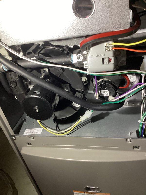 Completed annual furnace maintenance and tune-up on residential heating unit. Performed comprehensive system inspection including burner assembly examination, confirmed proper flame characteristics with uniform blue flame pattern across all burners, verified blower motor operation, inspected electrical connections and wiring throughout unit, and checked all safety controls including Resideo control components. All systems tested and operating within normal parameters. Unit photographed for service documentation.