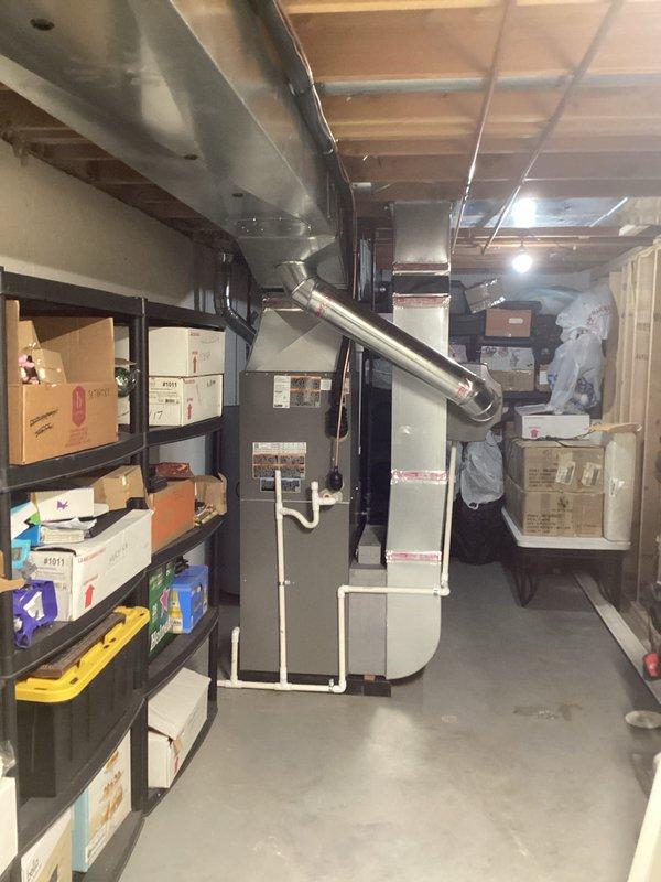 Completed full HVAC system installation including a 90,000 BTU furnace and 3-ton air conditioning unit with left-side configuration in basement utility area. Installed new ductwork connections, white PVC venting system with proper drainage routing, and integrated humidifier into the system. Reconnected all electrical and mechanical components, secured all piping with appropriate brackets and supports, and ensured proper clearances around water heater and existing utilities. All mechanical and electrical permits were obtained prior to installation, and system was tested for proper operation upon completion.