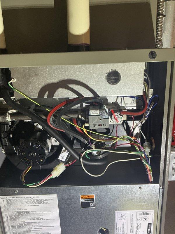 Technician responded to service call and performed diagnostic evaluation of heating unit. Upon inspection, discovered failed heat exchanger requiring replacement. Removed access panels to assess internal components and document condition. Verified unit was under full warranty coverage. Ordered replacement heat exchanger (part #11X42) from Lennox supply house for warranty replacement. Photographed internal components including blower assembly, gas valve, electrical connections, and wiring configuration for documentation purposes. Unit taken out of service pending heat exchanger replacement under manufacturer's full warranty program.